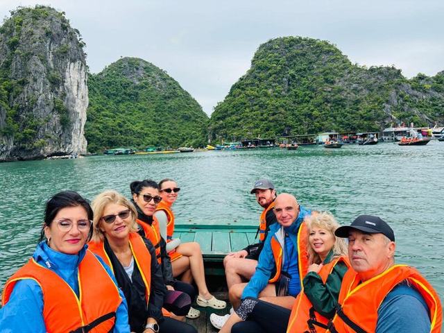 A cruise boat heading out into Halong Bay